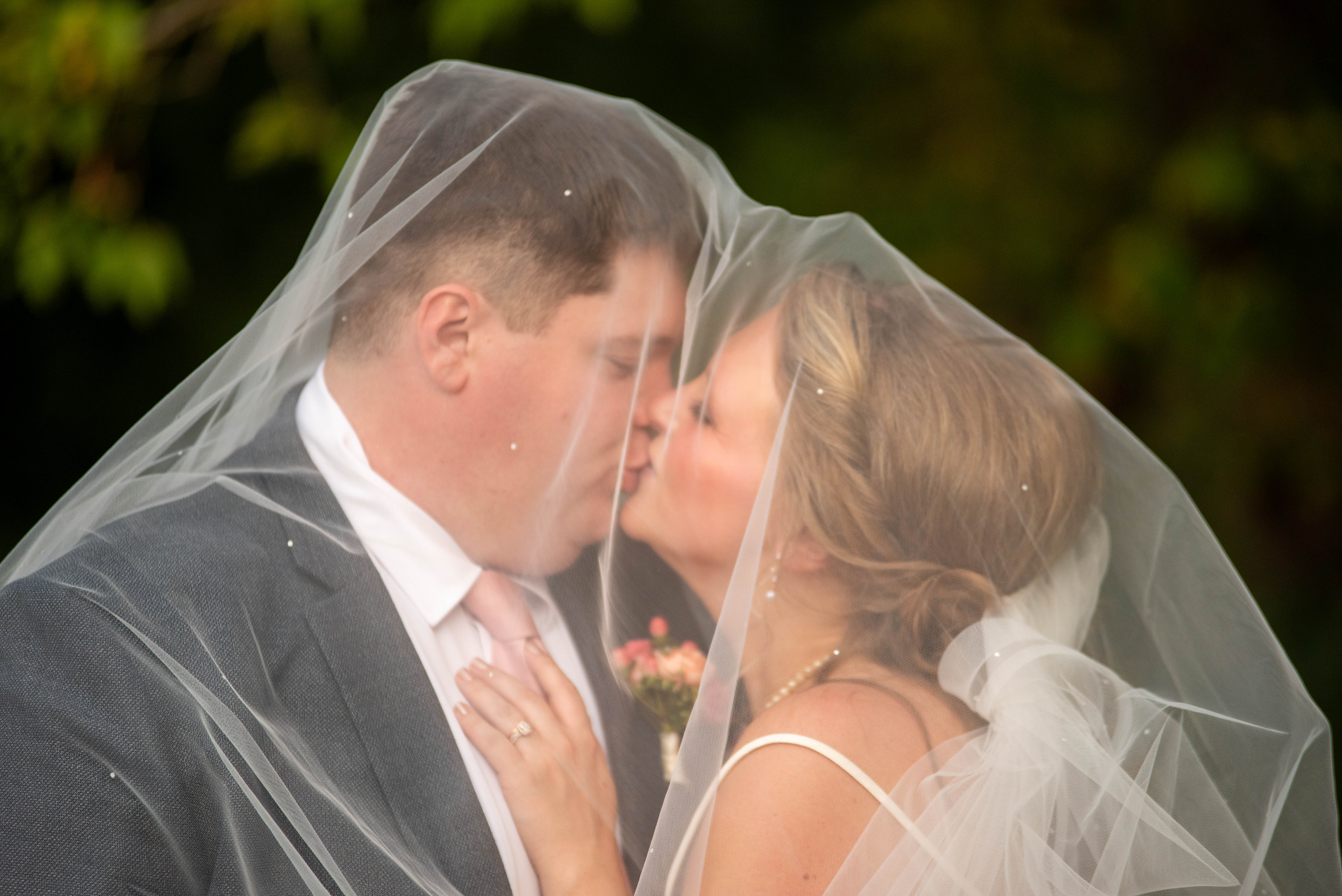 kissing uder the wedding veil